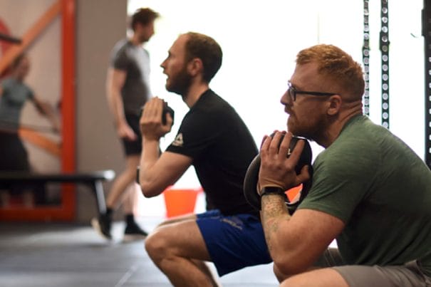 two mans with kettlebell