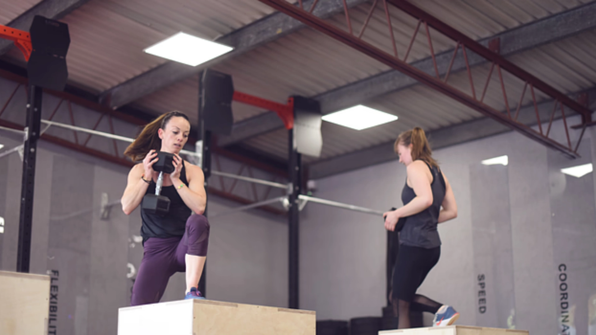 two womans on box with weight training